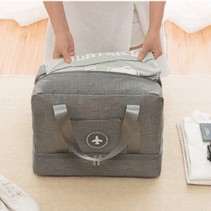 Person packing a stylish duffel bag with travel essentials for an adventure.