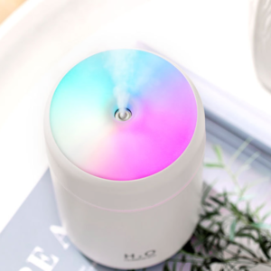 Sleek white essential oil diffuser releasing mist, enhancing relaxation and wellness in modern interiors.
