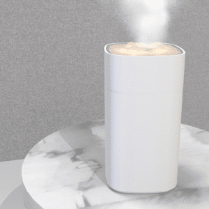 Sleek white humidifier with mist on elegant marble surface, perfect for modern home decor.
