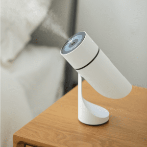 Sleek white humidifier on a wooden nightstand, enhancing bedroom comfort and air quality.
