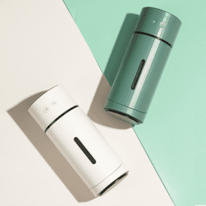 Sleek modern thermos containers in white and green for stylish, on-the-go beverage storage.