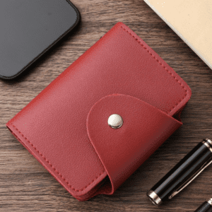 Stylish red wallet on wooden surface with smartphone and pen, perfect for modern lifestyle accessories.