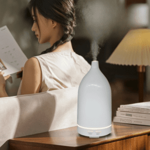 Cozy living room with a woman reading, diffuser creating a calming atmosphere for relaxation.