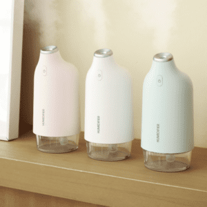 Stylish pastel humidifiers in pink, white, and mint green enhance home decor and air quality.
