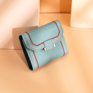 Elegant pastel blue wallet with decorative stitching, stylish design, and modern metallic clasp.