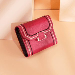 Vibrant pink leather wallet with elegant clasp and stylish design for fashionable accessories.