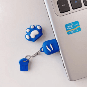 Playful USB flash drive covers on a modern laptop, blending fun design with tech functionality.